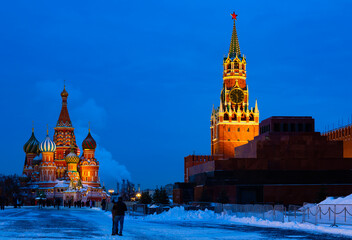Fototapeta na wymiar Evening St. Basil's Cathedral and the Spasskaya Tower of the Moscow Kremlin on Red Square in winter, Russia..