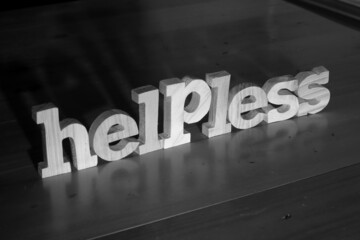 Helpless, text words typography written with wooden letter on black background, life and business negativity