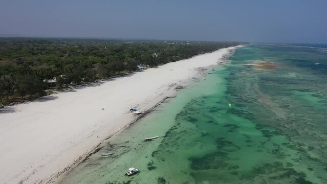 boats jachts on water sea Drone view Coastline Diani beach landscape Kenyan African Sea  aerial 4k waves blue indan ocean tropical mombasa turquoise white sand East Africa palms paradise wit coral
