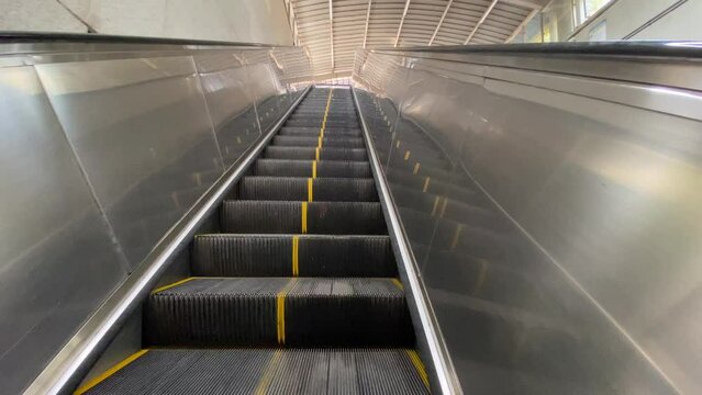 Popular tourist destination empty as people self isolate during COVID-19 coronavirus pandemic. Empty Escalator. Stairs. Going up
