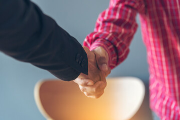 Team Business Partners shaking hands together to Greeting Start up small business in meeting room....