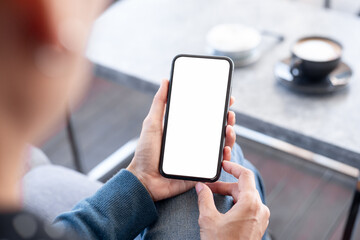 cell phone blank white screen mockup.hand holding texting using mobile on desk at office.background empty space for advertise.work people contact marketing business,technology