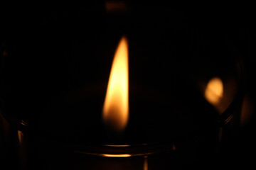 burning candle in the dark