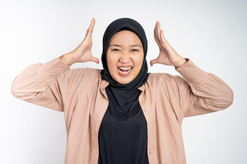 angry asian muslim woman with hijab looking at camera