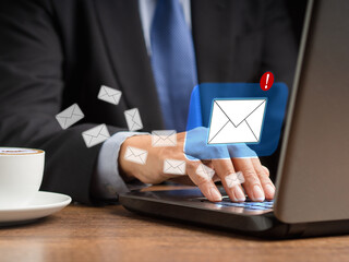 Businessman receives a new message with email icons on a virtual screen