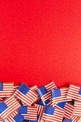 American flags flat lay on the red background with copy space. Happy Independence day USA.