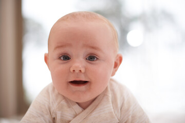 Im all about the cuteness. Shot of a cute and adorable baby boy at home.