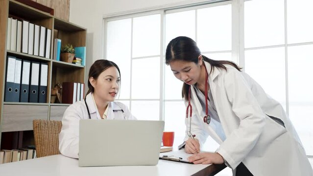 4K 50fps, Asian female medical student wearing a white shirt  ask for advice. about the sickness of the patient and the doctor's teacher in the office of the hospital