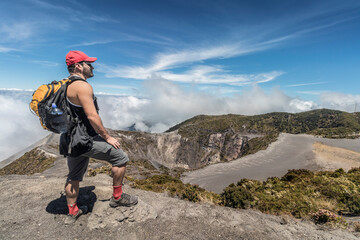 tourist with backpack contemplating the landscape in the Irazu Volcano National Park in Costa Rica