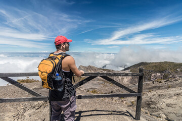 tourist with backpack observing the landscape in the Irazu Volcano National Park in Costa Rica