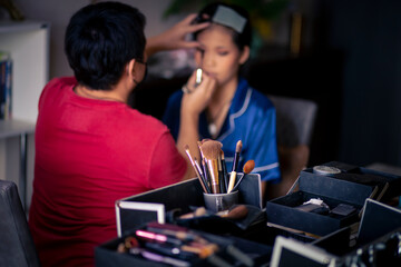 selective focus Make-up converter on makeup artist's table with lots of makeup artist tools. blur background makeup artist doing makeup beautiful girl There is space for text.