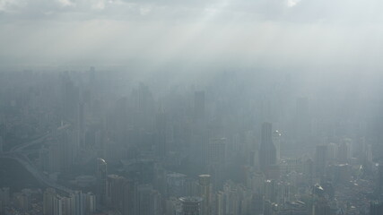 Obraz premium The beautiful city overlook view from the top of one skyscraper with the cloudy sky