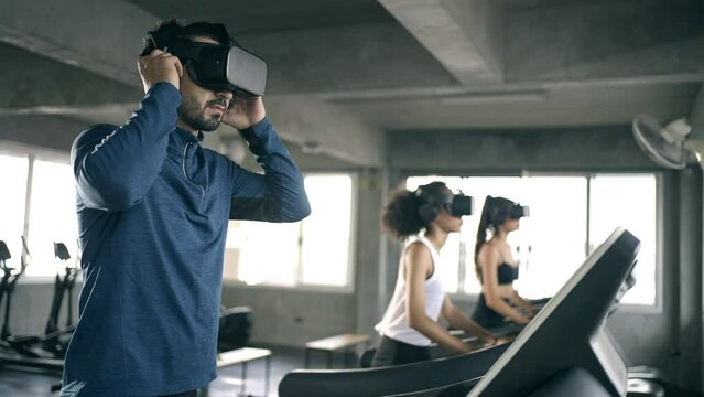 Healthy athletic man and woman in sportswear wearing VR glasses jogging exercise on treadmill in virtual reality cyberspace at fitness gym. Metaverse digital entertainment technology and sport concept