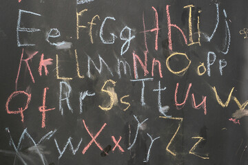 The coloured letters ABC are written by the child on the blackboard © Irina