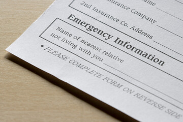 Closeup of the emergency contact information field on a patient information form isolated on a...