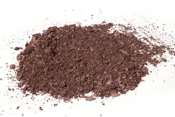 Scattered dark brown eye shadow isolated on a white background
