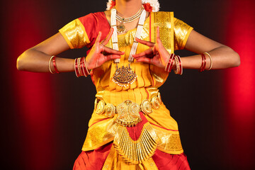 Close up shot, bharatanatyam dancer showing mudra or hand gestures on stage - cocnept of Indian culture, classical dancer and tradition.
