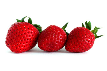 three ripe strawberries with green tails on a white background