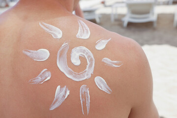 Persons back with sunscreen picture of sun on it, protect skin from damage