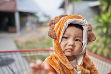toddler in animal costume is about to cry
