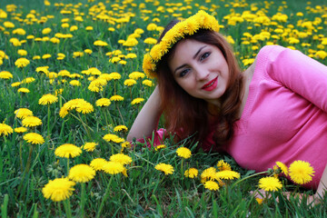 Naklejka na ściany i meble young woman on dandelion meadow