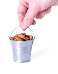 almonds in a bucket on a white background