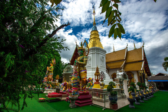 Background of religious attractions in Thailand's Chiang Mai Province, Wat Phra Pan (Wat Phranon Mee Pukha) features a large, beautiful Buddha image.