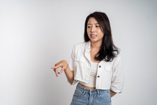 asian woman feeling disgusted and pointing at something