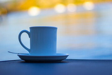 Coffee cup on sun lounger by the beach