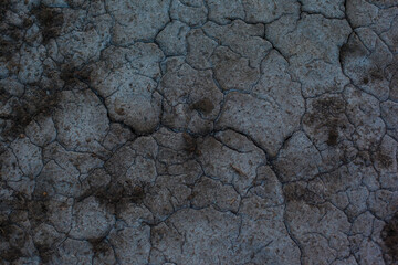 Dark gray background with cracks and hollows
