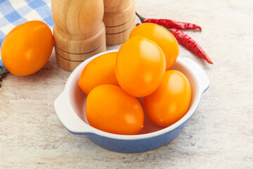 Sweet ripe yellow tomato in the bowl