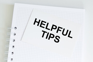 a card sign with helpful tips text message isolated on the table.