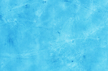 Aerial view of the beautiful blue texture of ice on the surface of the lake in winter