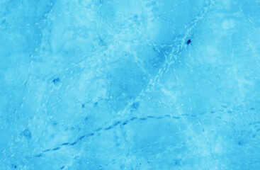 Aerial view of the beautiful blue texture of ice on the surface of the lake in winter