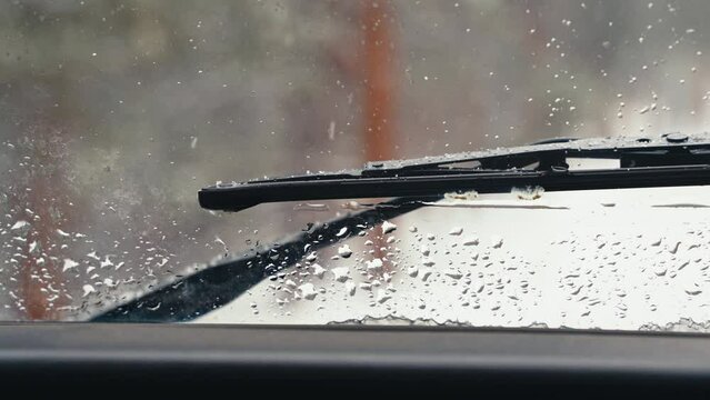 Windshield Wiper Seen From Inside Land Rover Defender D90 Off-Roading Through Snowy Pine Tree Forest Woods.