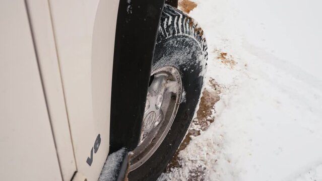 SUV Wheel Backing Up Sliding On Snow And Turning To Take Off Driving Forward On Snow Covered Off-Road Terrain.