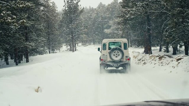 Land Rover Defender D90 Off-Roading Through Snowy Back Country Wintry Road In Rocky Mountains Alpine Forest Woods Near Nederland Boulder Colorado With Snowfall.