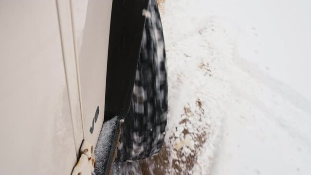 SUV Wheel Burning Out On Snow Covered Muddy Terrain Unable To Take Off.