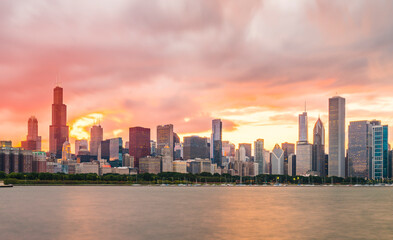 Fototapeta na wymiar chicago,illinois,usa. 8-11-17: Chicago skyline at sunset with cloudy sky and reflection in water.