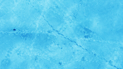 Aerial view of the beautiful blue texture of ice on the surface of the lake in winter
