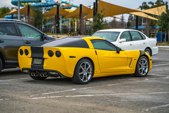 Yellow corvette in the parking lot.