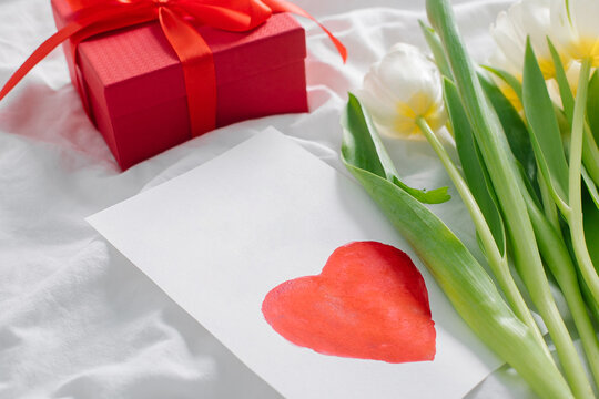 Womans day, mothers day concept. White tulips, gift present, greeting card with text I love mom