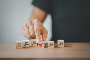 senior hand choosing red increasing percent among black decreasing percent on wooden desk, business development, increasing interest, payment, profit concept