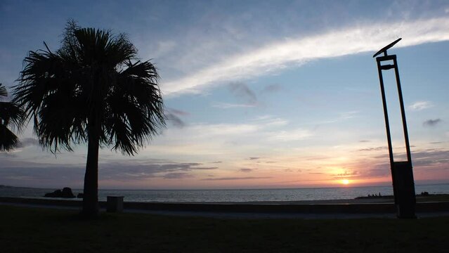 CHTAN-CHO, OKINAWA, JAPAN - AUGUST 2021 : View of Araha beach (Ocean or sea) in dusk. Sunset sky and sea. Romantic summer holiday, vacation and resort concept video.