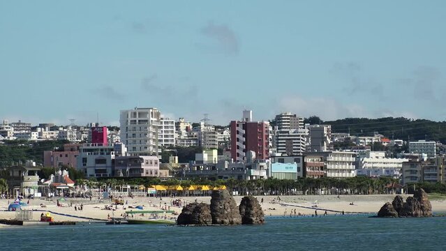 CHTAN-CHO, OKINAWA, JAPAN - AUGUST 2021 : View of Araha beach (Ocean or sea). Wide view, time lapse shot in daytime. Summer holiday, vacation and resort concept video.