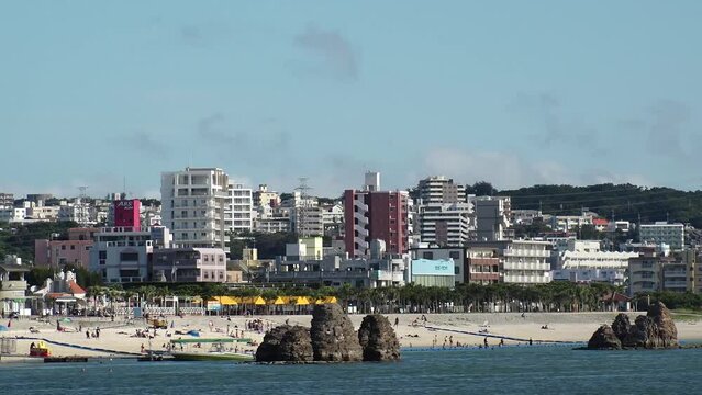 CHTAN-CHO, OKINAWA, JAPAN - AUGUST 2021 : View of Araha beach (Ocean or sea). Wide view, time lapse shot in daytime. Summer holiday, vacation and resort concept video.