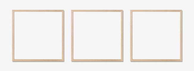 Picture frame mockup. Set of three square oak wooden frames on white wall. Template for artwork,...