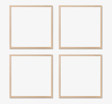 Picture frame mockup. Set of four square oak wooden frames on white wall. Templates for artwork, painting or poster