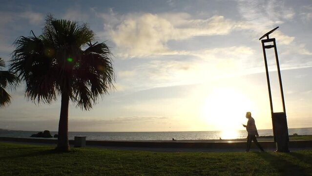CHTAN-CHO, OKINAWA, JAPAN - AUG 2021 : View of Araha beach (Ocean or sea) in sunset time. Wide view, long time lapse shot, dusk to night. Summer holiday, vacation and resort concept shot.