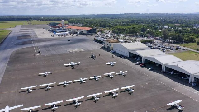 Large number of light aircraft parked on tarmac, Cibao Airport; aerial